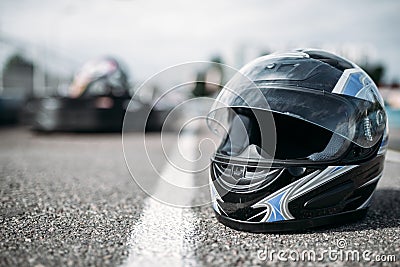 Racer helmet on asphalt, karting sport concept Stock Photo