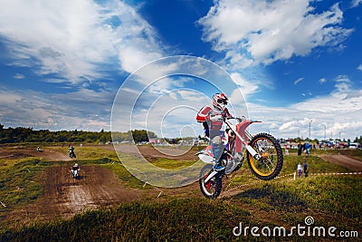 Racer jumps on trampoline motorcycles dirtbike blue sky Stock Photo