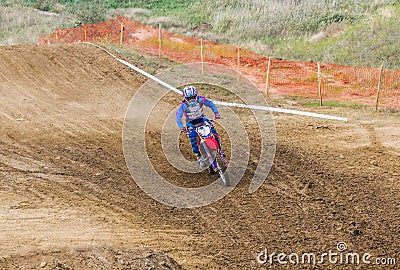 The racer on a motorcycle participates in race motocrosses, goes on sand. Stock Photo