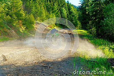 Racer with yellow helmet on green quad enjoying his ride outdoors. Stock Photo