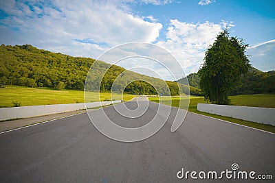 Racetrack straight to the mountain with clear sky. Stock Photo
