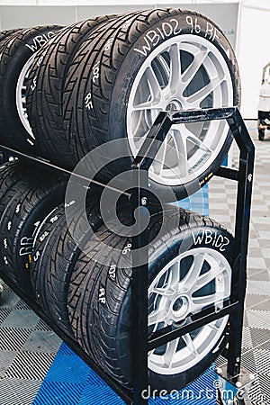 Racing car tires storage. Storage of tires in a row Stock Photo