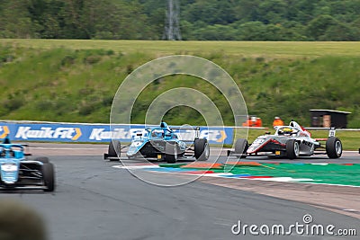 Racing track with F4 Championship cars cornering on the track at Thruxton Editorial Stock Photo