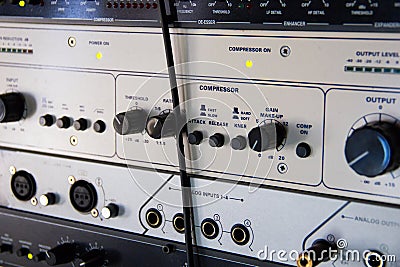 A rack of audio compressors in a recording studio Stock Photo