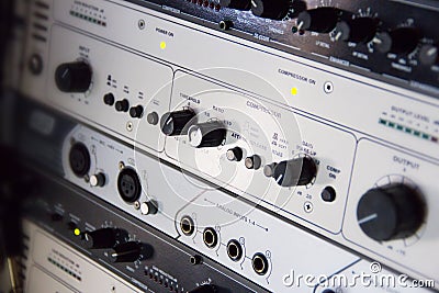 A rack of audio compressors in a recording studio Stock Photo