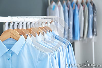 Rack with clean clothes on hangers after dry-cleaning Stock Photo