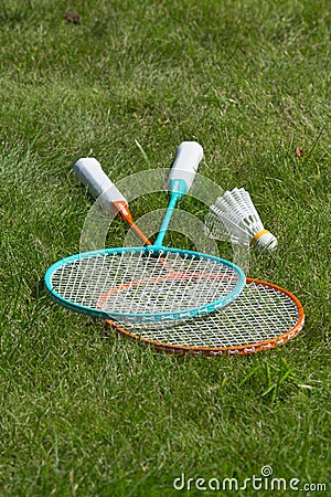 Rackets and a shuttlecock for badminton on the grass. Stock Photo