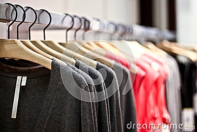 Racks of sweaters and shirts hanging in a store Stock Photo