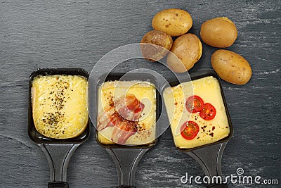 Raclette trays and potatoes Stock Photo