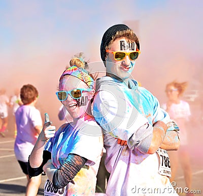 Rad couple posing after running a color race Editorial Stock Photo
