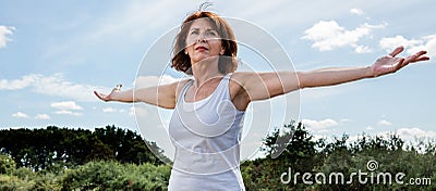 Radiant mature woman in harmony with nature Stock Photo