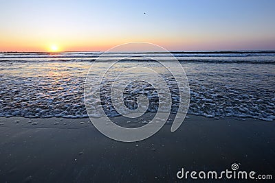 Radiant sea beach sunrise Stock Photo