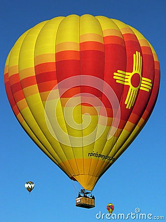 Radiant Zia balloon glowing in the skies at the Albuquerque International Balloon Fiesta Editorial Stock Photo
