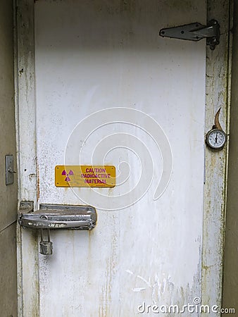 Radiation warning on a locked door Stock Photo