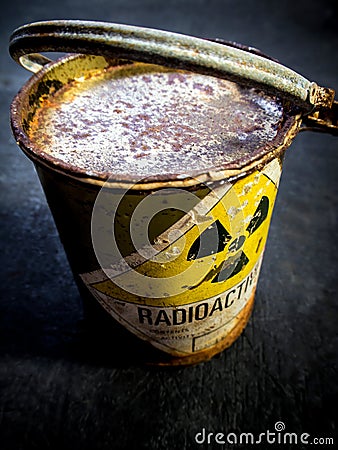 Radiation warning sign on the rusty and decay radioactive material container Stock Photo