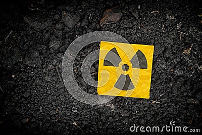 Radiation warning sign on soil background Stock Photo