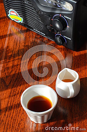 A radio a cup of coffee and a pot of huney Stock Photo