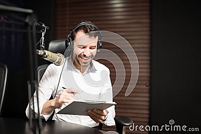 Radio jockey interviewing a guest from studio Stock Photo