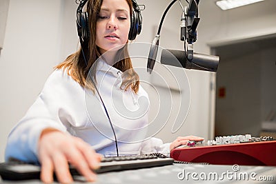 Radio Jockey Wearing Headphones In Studio Stock Photo