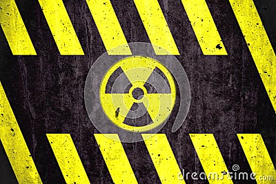 Radioactive ionizing radiation danger symbol with yellow and black stripes painted on a massive concrete wall Stock Photo