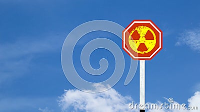The radioactive symbol on red warning sign with blue sky background Stock Photo