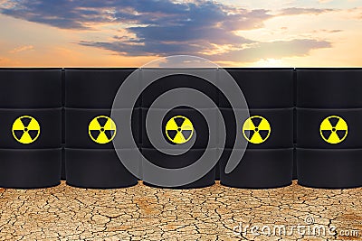 Radioactive waste against dry earth and sky clouds. Environment protection and toxic nuclear pollution concept Stock Photo