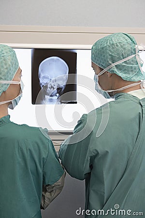 Radiologists Examining Xray Of Skull Stock Photo