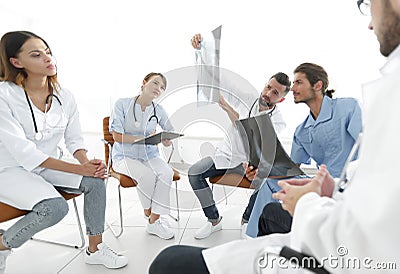 Radiologists and a surgeon discussing a radiograph of a patient Stock Photo