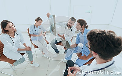 Radiologists and a surgeon discussing a radiograph of a patient Stock Photo