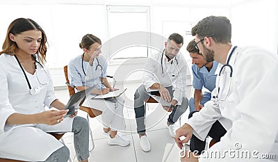 Radiologists and a surgeon discussing a radiograph of a patient Stock Photo