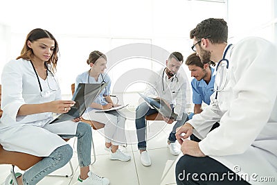 Radiologists and a surgeon discussing a radiograph of a patient Stock Photo