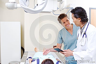 Radiology technician with patient and physician Stock Photo