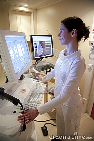 Radiology technician performs mammography test Stock Photo