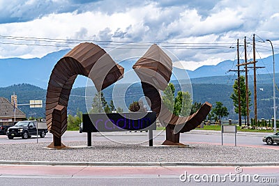 Radium Hot Springs, British Columbia, Canada - July 7, 2022: Bighorm ram sheep sculpture artwork in a roundabout traffic circle in Editorial Stock Photo