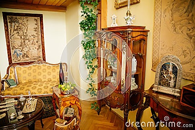 Radun castle interior, Neo-Classical chateau, yellow library, baroque and rococo carved wooden furniture, armchairs, table with Editorial Stock Photo