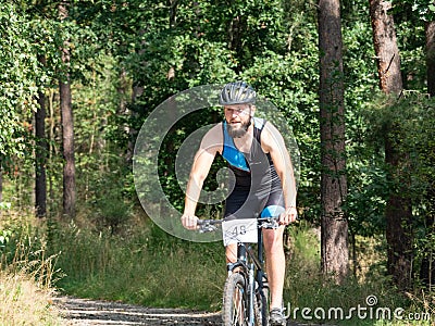 Bearded racer on a black bicycle hold brakes Editorial Stock Photo