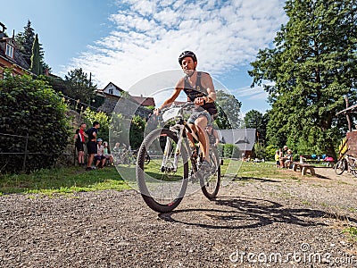 The triathlete leaves the depot for the cycling circuit Editorial Stock Photo