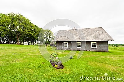 RADVILISKIS, LITHUANIA - JUNE 12, 2014: Unique Village and Rural Area in Lithuania with Wooden Building. Green grass and forest in Editorial Stock Photo