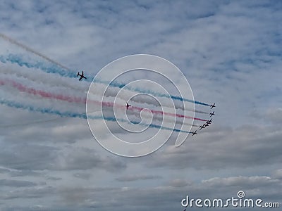 RAF Red Arrows in action with coloured smoke Stock Photo