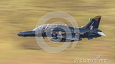 RAF T2 Hawk military jet aircraft trainer in flight from RAF Valley on a low level training mission in Wales Editorial Stock Photo