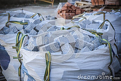 Raffia large sack full of granite cobblestones Stock Photo