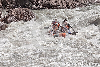 Rafting, brave and courageous people conquer water obstacles on a mountain river on rafts. Editorial Stock Photo