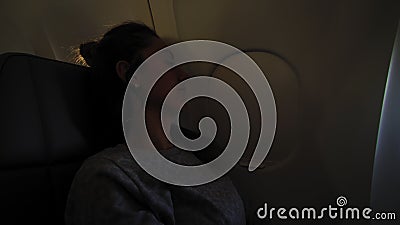 Ragazza al portico nell'aereo Giovane donna seduta sul sedile del passeggero e che guarda fuori dal finestrino dell'aereo video d archivio Ragazza al portico nell'aereo Giovane donna seduta sul sedile del passeggero e che guarda fuori dal finestrino dell'aereo video d archivio