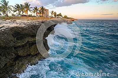 Raging ocean, rocky coast at sunset. Malecon in Santo Domingo. Caribbean travel Stock Photo