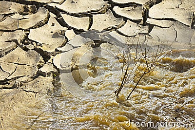 Raging waters and murky after several days of rain versus infertile land burned by the sun - concept image Stock Photo