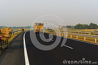 15.11.2022. Raiganj, West Bengal, India. Black asphalt well marked newly constructed national highway road in Raiganj Editorial Stock Photo
