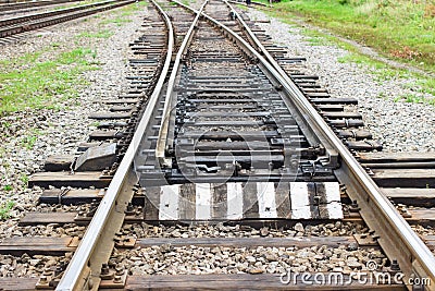 Rail tracks with rail sleepers at the railway pointwork. Change of direction. Railway arrows with rail track elements Stock Photo