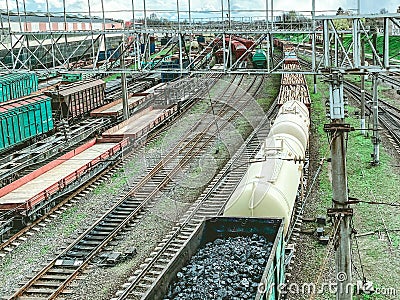 Railroad in the city. metal rails. on the road are freight, red freight wagons, large and capacious wagons transport black bulk Stock Photo