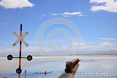 Railroad crossing sign with Chinese letters with an approaching train in winter Stock Photo