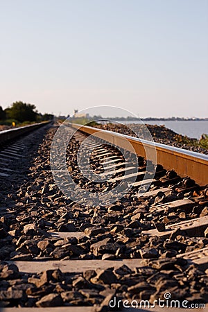 Railroad going to the distance near the shore Stock Photo